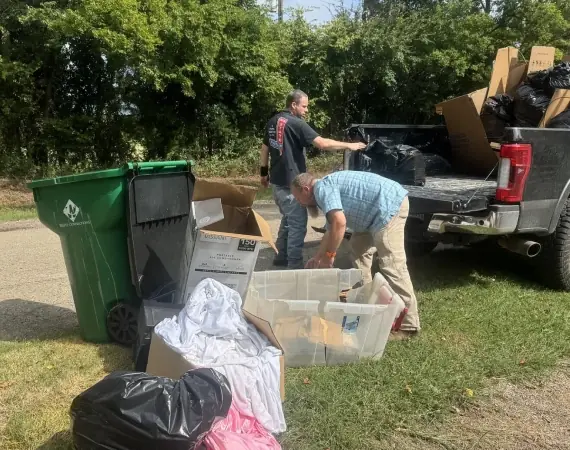 Crew loading totes and bedding into a pickup